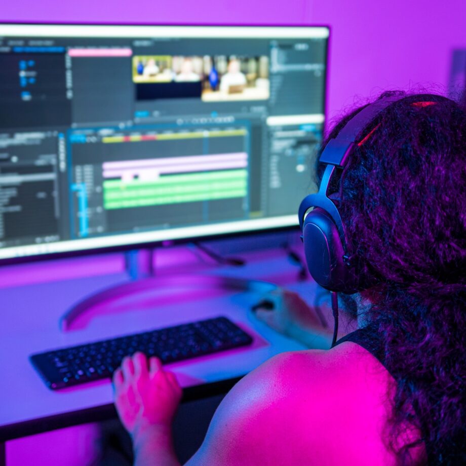 Person working from home at night. Video editor editing a commercial.